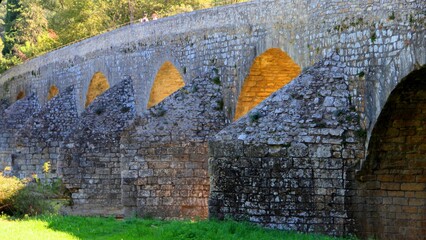 Pont Charles Martel bridge on a sunny day, green grass around, La Roque-sur-Ceze, France