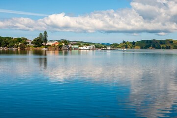 Beautiful seascape under blue cloudy sky with Hokianga Harbor in the background in New Zealand