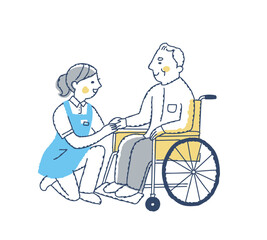 笑顔で話す車いすのシニア男性と介護スタッフ