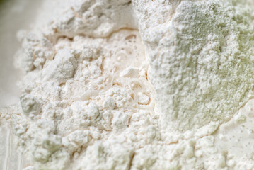 water is added to flour. Kneading dough for cooking. Close-up. Flour and water are mixed.