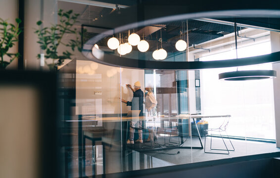 Senior colleagues standing near whiteboard in meeting room