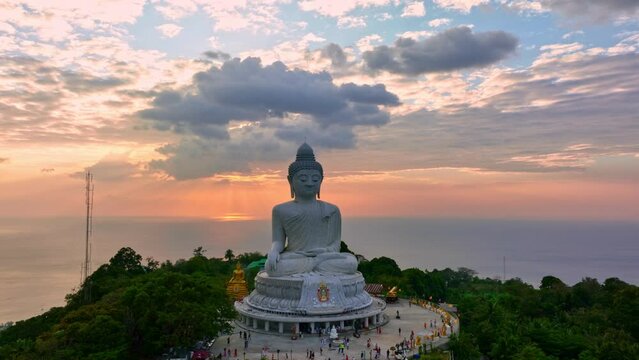 aerial view Phuket big Buddha in beautiful sunset..the sun shines through the clouds impact on ocean surface.The beauty of the statue fits perfectly with the charming nature..cloud scape background.