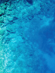 Top view of beautiful turquoise ripple on the sea surface and seabed via crystal clear blue water