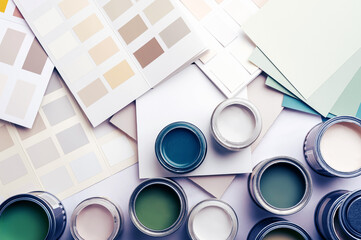 Tiny sample paint cans during house renovation, process of choosing paint for the walls, different...