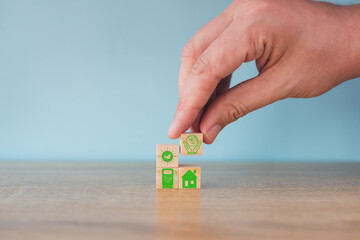 Carbon neutral concept. Net zero greenhouse gas emissions target. Climate neutral long term strategy. Stacking wooden cubes with green net zero and save world icon on grey background.
