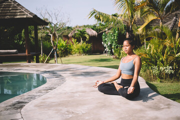 Calm woman meditating in lotus pose