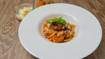 malloreddus or Sardinian gnocchetti, typical Sardinian pasta, with wild boar sauce, basil and pecorino cheese
