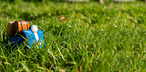 Naklejka premium Toy scooter on green grass. Banner. Place for text. Delivery, active lifestyle, travel concept.