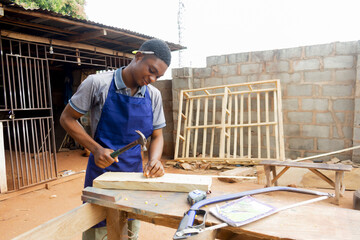 young african carpenter standing holding working