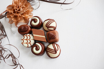 set of chocolates in a gift box and a bouquet of roses