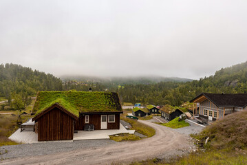 Village in Norway with misty background and forest