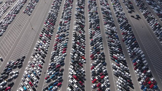 Aerial view of a parking lot full of used cars.