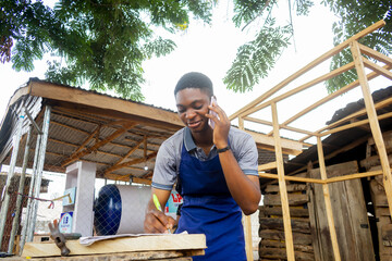 young african carpenter standing holding working calling