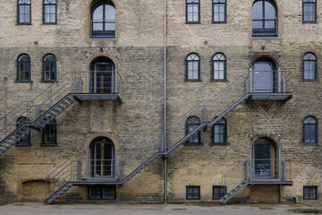 Fototapeta na wymiar Front exterior view of typical old brick building along waterside of Copenhagen, Denmark. 