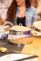 restaurant table with details of a traditional container to keep food warm, kitchen utensil design, household objects