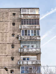 Worn out apartment building from the communist era against blue sky in Bucharest Romania. Ugly traditional communist housing ensemble
