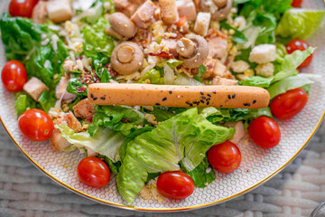 Salad With mini tomatoes, bread stick ,vegetables ,mushroom and chicken