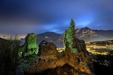 Fototapeta na wymiar Mysterious night at the medieval ruins of Penede castle. Nago Torbole, Trentino, Italy.