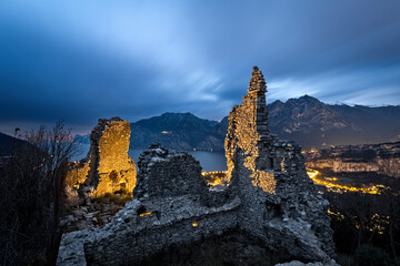 Obraz premium Mysterious night at the medieval ruins of Penede castle. Nago Torbole, Trentino, Italy.
