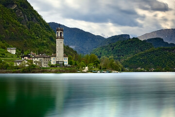 The lake of Corlo and the bell tower of the village of Rocca. Arsié, Belluno province, Veneto,...