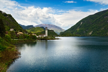 The lake of Corlo and the bell tower of the village of Rocca. Arsié, Belluno province, Veneto,...