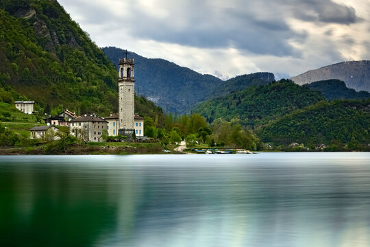The lake of Corlo and the bell tower of the village of Rocca. Arsi&eacute;, Belluno province, Veneto, Italy.