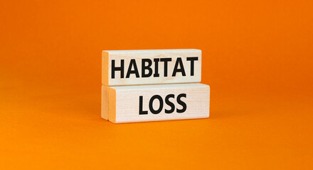 Habitat loss symbol. Concept words Habitat loss on wooden block. Beautiful orange table orange background. Business habitat loss concept. Copy space.