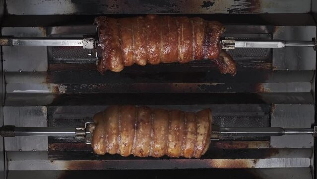 Modern cooking of Balinese Suckling Pig on alumunium rotisserie