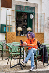 Woman Sitting In Cafe Bar And Using A Mobile Phon