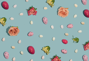 Composition with roses and easter eggs on blue background. Minimal spring concept