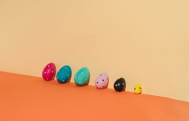 Easter eggs on orange colors background and effect of sunlight. Minimal easter concept.