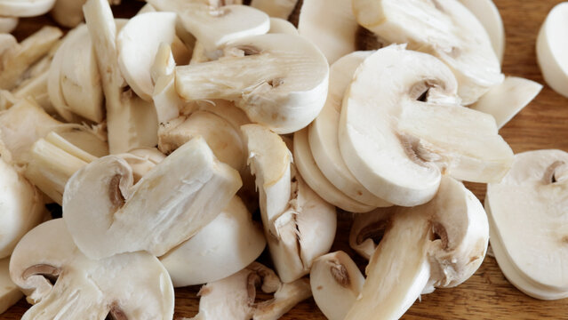 morceaux de champignons de Paris en gros plan, sur une table en bois
