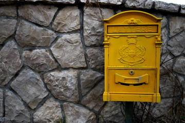Old yellow mailbox in Montenegro