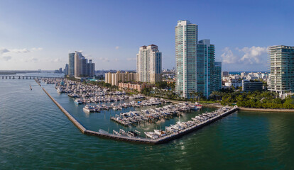 Fototapeta na wymiar Boat harbor at Meloy Channel with coastline skyscrapers at Miami Beach, Florida. Aerial view of a harbor near the bridge in an intracoastal area.