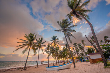 Obraz na płótnie Canvas Sunset on the beach. Paradise beach. Tropical paradise, white sand, beach, palm trees and clear water.