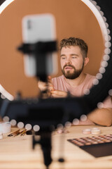 Man make up vlogger recording broadcast about cosmetics and tutorials for make-up artist