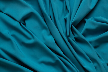 Blue wrinkled plain fabric as background close-up