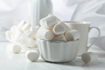 White marshmallows on a wooden table.