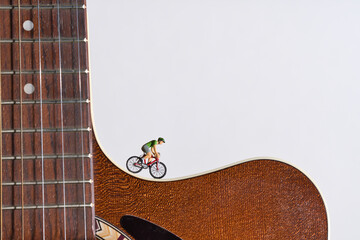 a man rides a racing bike on an acoustic guitar