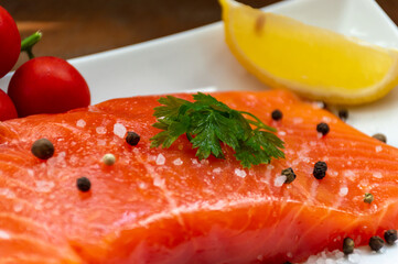 Nice piece of salmon with ingredients for cooking