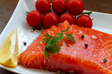 Salmon fillet with salt, pepper, lemon and cherry tomatoes
