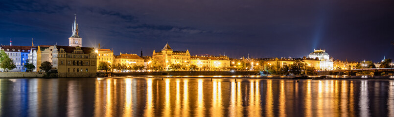 Fototapeta na wymiar Night panoramic view of the Vltava River, Smetana Embankment, and the National Theatre in Prague, Czech Republic