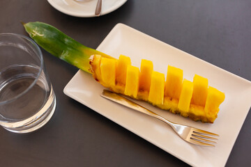 Beautifully sliced pineapple on white plate, beautiful serving pineapple on festive table