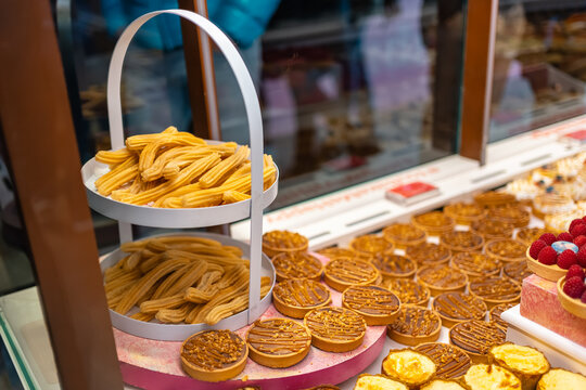 Showcase with various products for breakfast and typical churros from Madrid, Mercado de San Miguel.