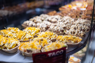 Showcase with various prepared food dishes to consume such as tapas and sandwiches, San Miguel Market, Madrid.