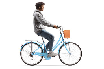 Obraz premium Full length profile shot of a casual young african american man riding a bicycle