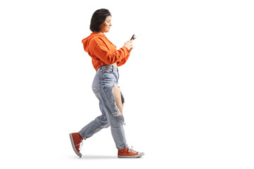 Full length profile shot of a gen z female using a smartphone and walking - obrazy, fototapety, plakaty