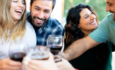 Group of happy friends celebrating the arrival of spring together with a backyard barbecue