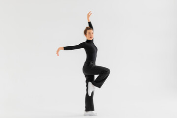 Fototapeta na wymiar Young Girl, professional hip-hop dancer in a black clothes performing over a Isolated white background with a plenty of copy space.