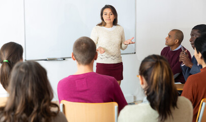 Fototapeta premium Teacher standing in front of whiteboard and teaching lesson